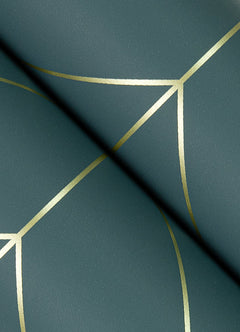 A close-up of Sander Geometric Wallpaper by York Wallcoverings features a dark green surface intersected with gold geometric lines, creating an abstract, modern pattern. A diagonal shadow crosses the wallpaper, adding depth and contrast to the design.