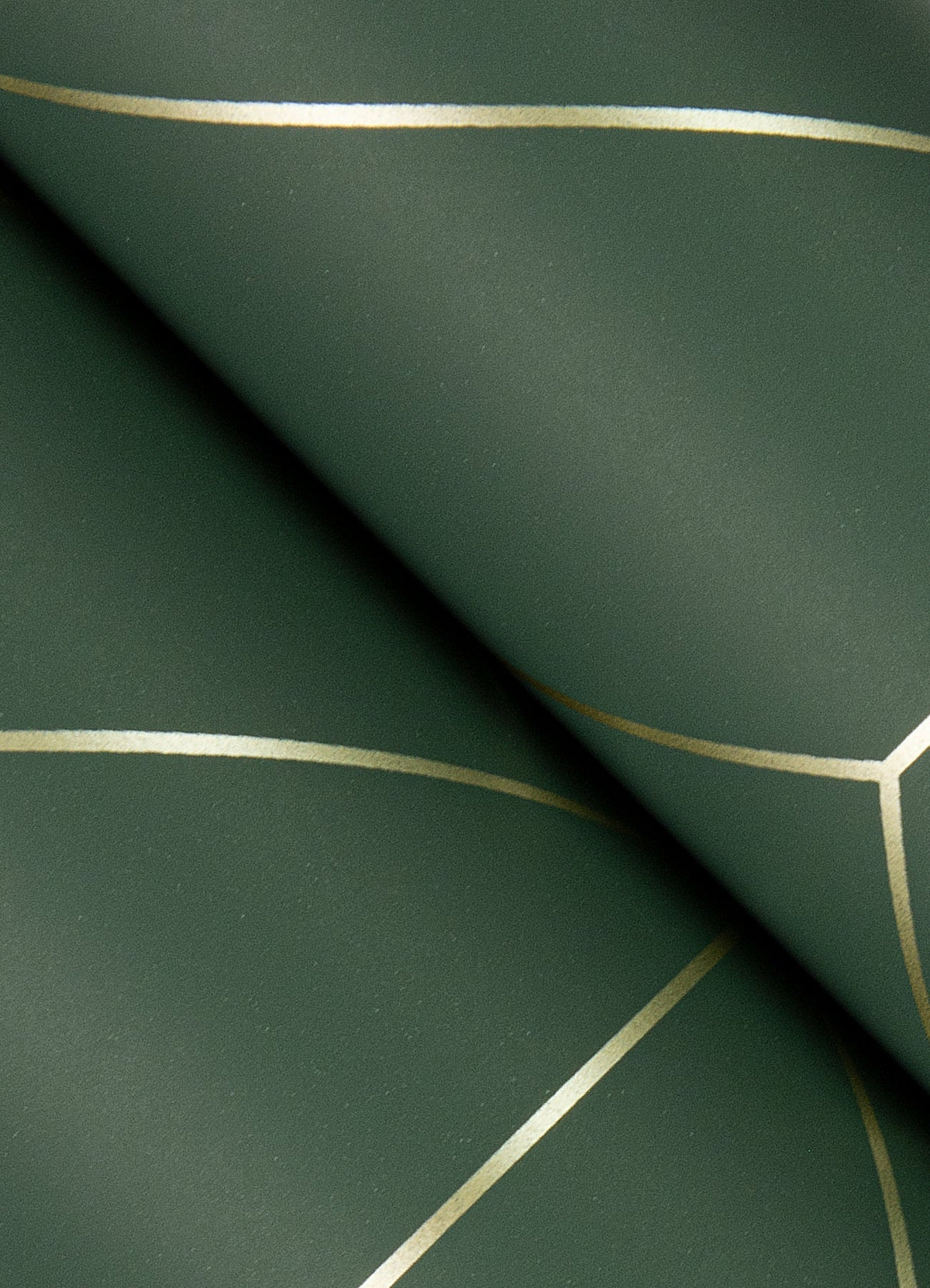 Transform your space with Sander Geometric Wallpaper by York Wallcoverings, featuring a dark green background adorned with thin, intersecting gold lines that create elegant geometric shapes. Displayed in overlapping layers, the wallpaper reveals a subtle shadow effect for added depth.