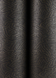 Hollenback Dotted Abstract Wallpaper by York Wallcoverings features a dark background adorned with an intricate pattern of small gold dots that create winding, maze-like lines and curves, giving the wallpaper a textured appearance. The design drapes in soft, vertical folds for an elegant effect.