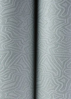 Close-up of Hollenback Dotted Abstract Wallpaper by York Wallcoverings, showcasing a light gray surface with a subtle, abstract dotted pattern and gentle folds in the center that create a textured, softly curved appearance.