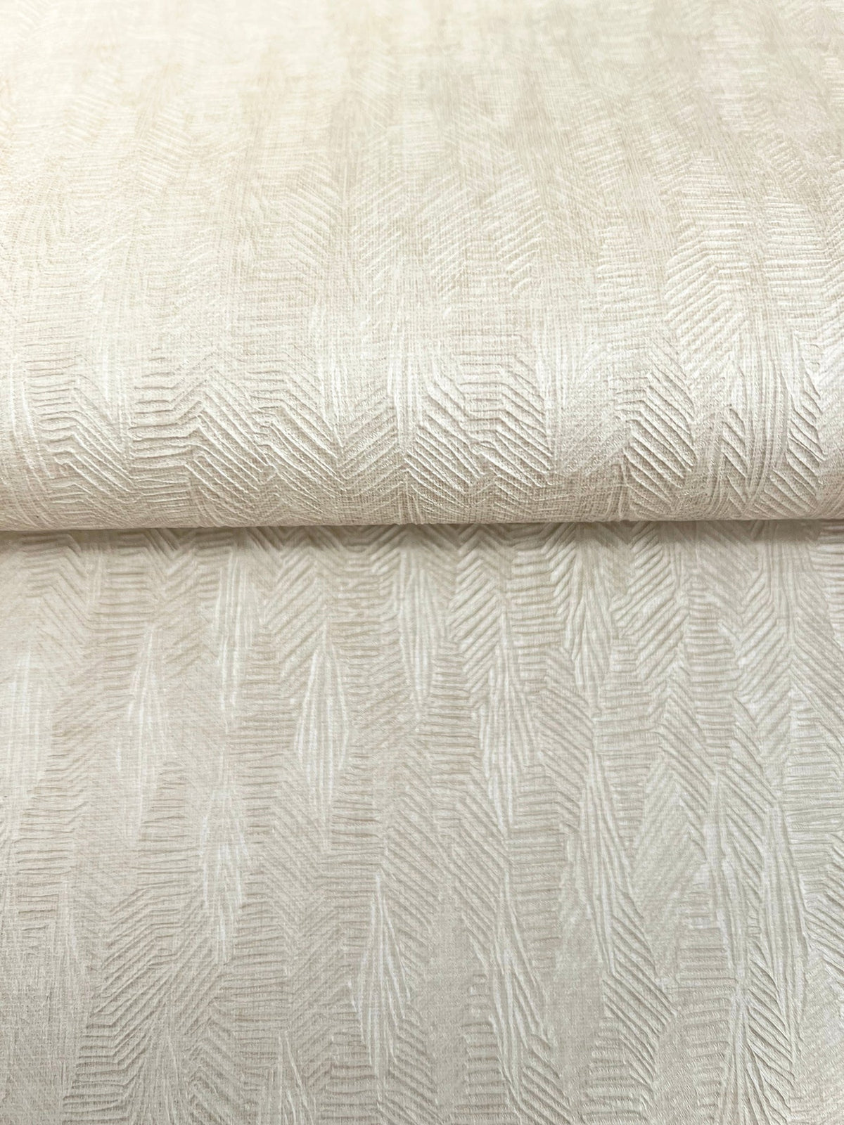 A roll of light beige Bryson Feathered Texture Wallpaper featuring a textured, repeating feathered or herringbone pattern.