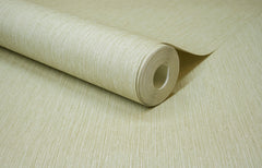 A close-up of a roll of Chesapeake Elijah Texture Wallpaper by York Wallcoverings, light beige and textured, partially unrolled on a matching surface.