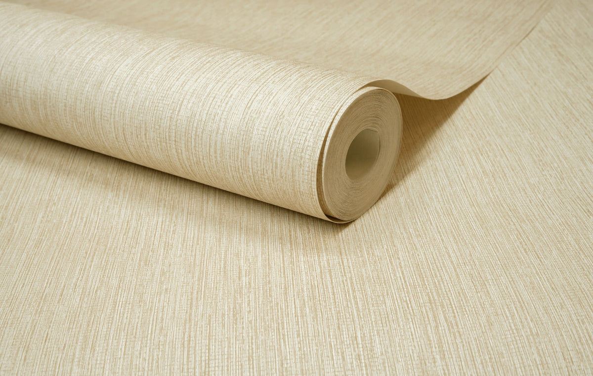 A close-up of the Chesapeake Elijah Texture Wallpaper by York Wallcoverings, in beige, partially unrolled on a matching surface.