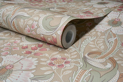 A close-up of the Chesapeake Liora Floral Trail Wallpaper by York Wallcoverings, partially unrolled to reveal its intricate floral and leaf pattern in soft beige, pink, and green tones.