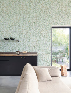 Modern living room with a beige sofa, black cabinets, wooden countertop, and Chesapeake Laverne Wildflowers Wallpaper by York Wallcoverings. A large window reveals a green garden outside, and a stack of wooden blocks sits on the floor near the window.
