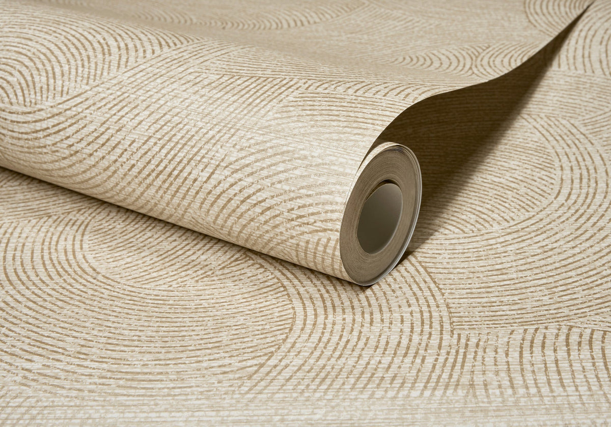 A partially unrolled roll of Chesapeake Harrison Swirling Geometric Wallpaper by York Wallcoverings, featuring a beige hue with a textured circular line pattern on a coordinated background.