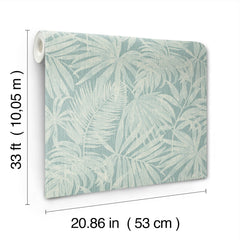 The Chesapeake Sonny Fronds Wallpaper by York Wallcoverings features a light blue background with a white tropical leaf pattern. Each roll measures 33 ft (10.05 m) long and 20.86 in (53 cm) wide.