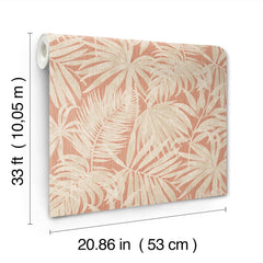 A roll of Chesapeake Sonny Fronds Wallpaper by York Wallcoverings, featuring a tropical leaf pattern in beige and light pink tones, measuring 33 ft (10.05 m) long and 20.86 in (53 cm) wide.