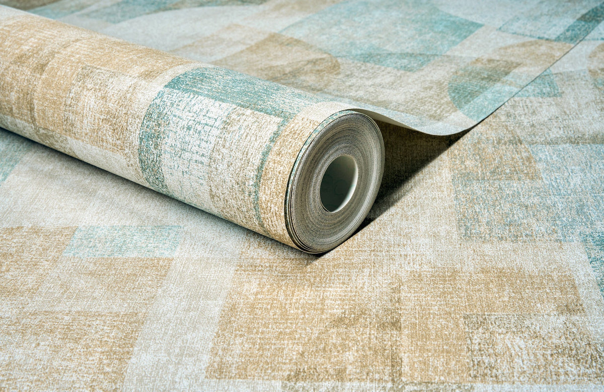 A roll of York Wallcoverings Chesapeake Cassandra Block Geometric Wallpaper, featuring a textured geometric pattern in beige and teal tones, is partially unrolled on a matching surface.