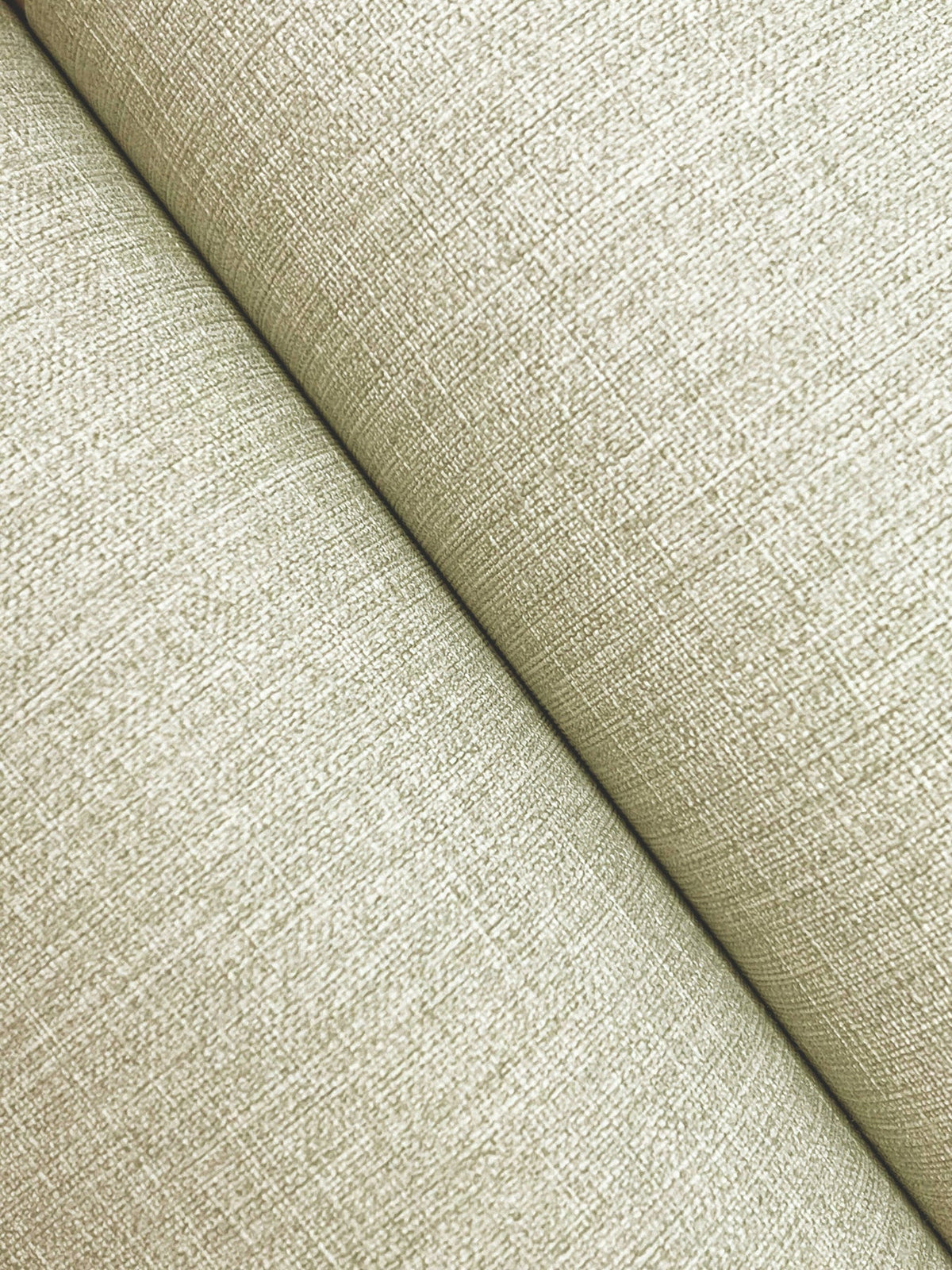 Close-up of two surfaces covered in Chesapeake Sonia Faux Linen Wallpaper by York Wallcoverings meeting at an angle, highlighting the detailed woven texture and a visible seam where the wallpaper panels join.