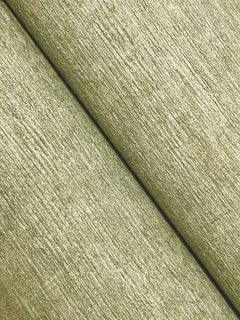 Close-up of two diagonally placed and parallel sections of Chesapeake Tansy Distressed Wallpaper by York Wallcoverings, featuring a light green, textured, grainy wood-inspired surface.