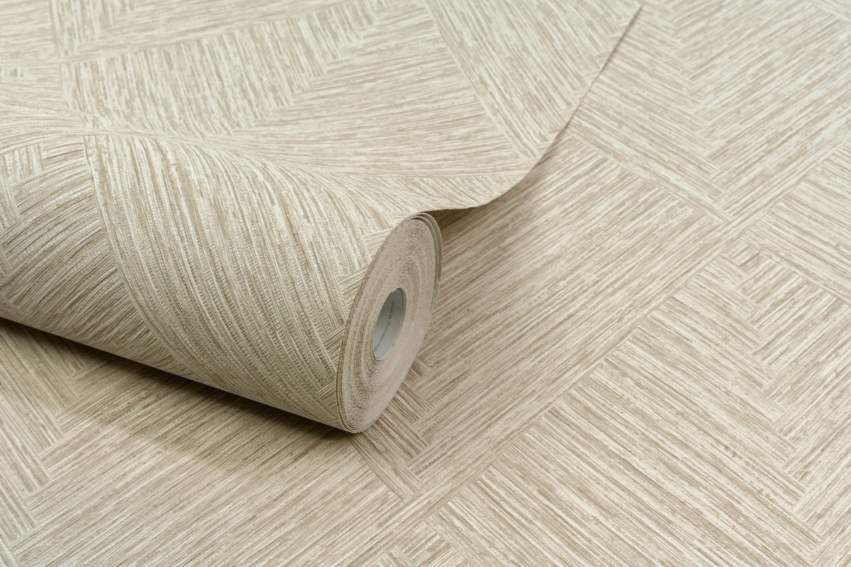 A roll of Chesapeake Hollis Textured Diamond Wallpaper by York Wallcoverings, featuring a beige geometric texture, is partially unrolled on a matching surface.