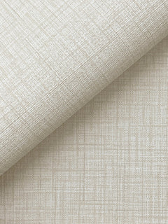A close-up of York Wallcoverings’ Beau Faux Fabric Wallpaper in light beige, featuring a subtle crisscross pattern and a linen-like texture with fine intersecting lines, partially rolled on a matching flat surface.