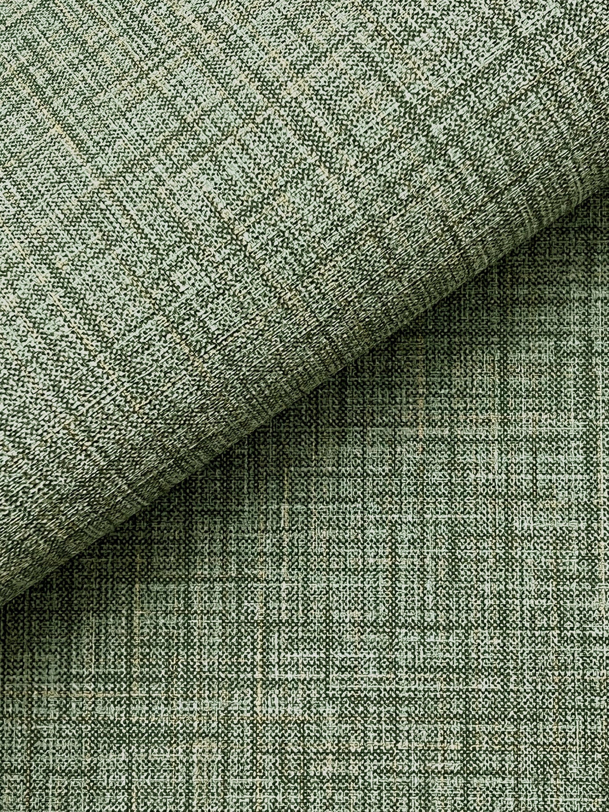 Close-up of Beau Faux Fabric Wallpaper by York Wallcoverings in light green, featuring a subtle grid pattern and two overlapping layers. The wallpaper’s textured weave and fine intersecting lines create a geometric, modern appearance.