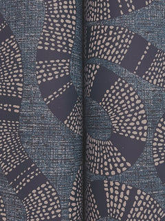 The Ophidia Wallpaper by York Wallcoverings features an abstract pattern with curving navy blue lines, dotted white circles, and a textured blue background divided down the center by a shadowed seam, evoking the look of book pages or folded material.