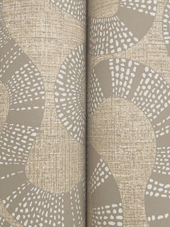 Close-up of York Wallcoverings’ Ophidia Wallpaper, featuring a tan and beige abstract pattern with curving lines and white dotted accents for added texture. Two rolls are placed side by side, forming a seam in the center.