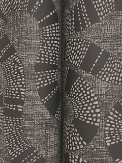 The Ophidia Wallpaper by York Wallcoverings features a black surface adorned with abstract white dotted and textured lines that form swirling, organic patterns and curves. Its symmetrical design creates a visually dynamic effect, evoking a sense of movement.