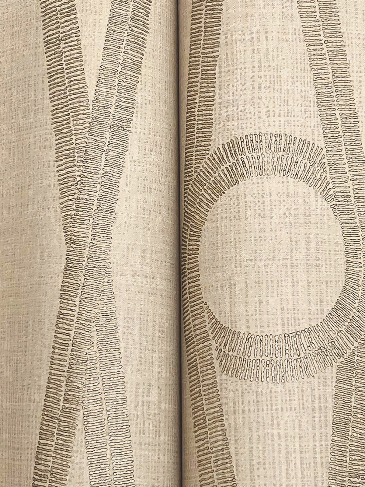 Close-up of the Henlein Wallpaper by York Wallcoverings in beige, featuring textured, overlapping lines that create abstract shapes—including a large circle and intersecting stripes—against a subtly patterned background.