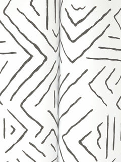 Black zigzag and chevron-like hand-drawn lines form a geometric pattern on a white background in the Sirih Wallpaper by York Wallcoverings.