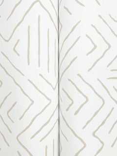 A close-up of the Sirih Wallpaper by York Wallcoverings showcases its white background adorned with a beige, hand-drawn zigzag and line pattern, creating a subtle geometric design. The wallpaper is pictured slightly folded down the center.