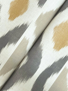 Close-up of Patan Wallpaper by York Wallcoverings, featuring an abstract brushstroke pattern in beige, tan, gray, and white tones. The wallpaper appears slightly folded, creating a soft crease through the center.