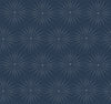 Starlight Wallpaper by York Wallcoverings features a geometric, symmetrical design with a repeating dark blue pattern accented by white dotted starbursts radiating from circular centers.
