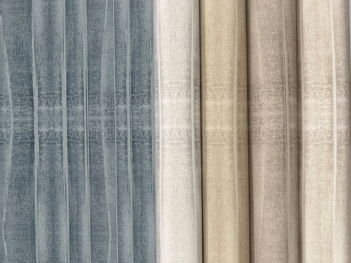 Five rolls of York Wallcoverings Grey Stone Wallpaper displayed side-by-side, featuring a vertical textured pattern in shades of grey, cream, and tan.