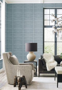 Grey Stone Wallpaper by York Wallcoverings on a living room wall, featuring a textured grey surface with a subtle horizontal ribbed pattern.