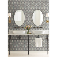 A bathroom vanity with two oval mirrors and vessel sinks set against Candice Olson Everlasting Wallpaper by York Wallcoverings.