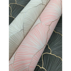 Two rolls of Candice Olson Luminous Gingko Wallpaper in pink and cream, laid over sections of the same pattern in dark gray.