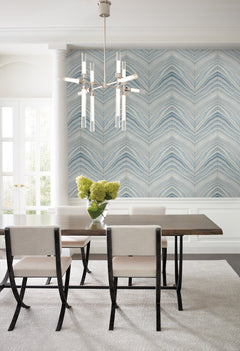 Dining room featuring Candice Olson Onyx Strata Wallpaper with a blue and white chevron pattern, a dark wood table with four light-colored chairs, and a modern chandelier.