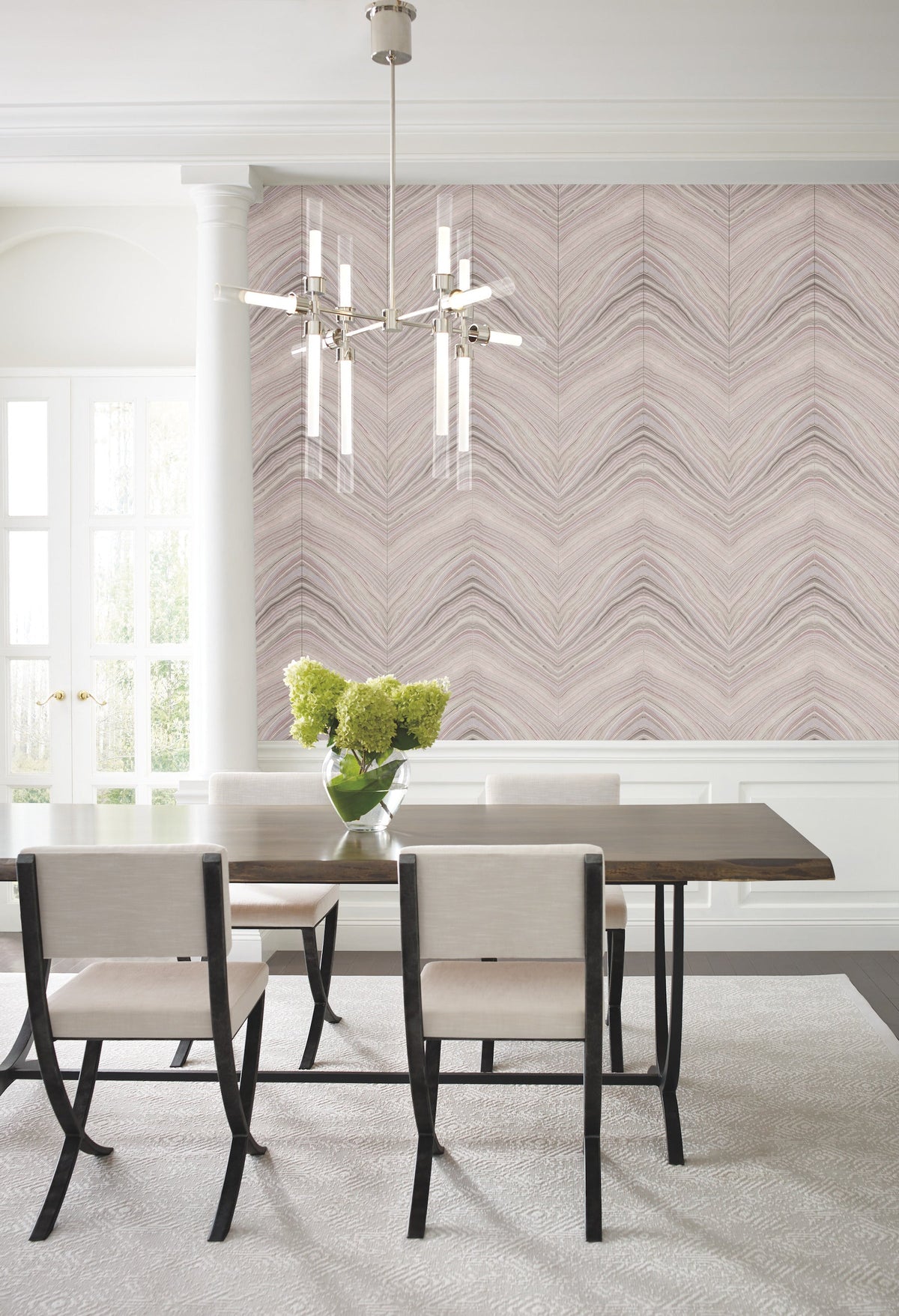 Dining room with a dining table and chairs set against a wall featuring York Wallcoverings Candice Olson Onyx Strata Wallpaper with a light-toned, chevron-like wave pattern.