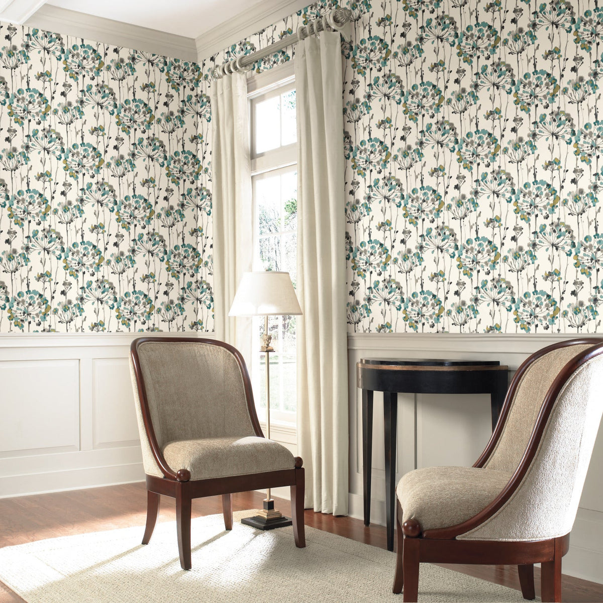 Two upholstered chairs set against a wall featuring Candice Olson Flourish Wallpaper with a repeating pattern of teal and grey stylized floral bursts.