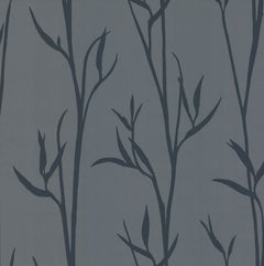 The Matcha Wallpaper by York Wallcoverings features dark blue silhouettes of leafy branches on a muted gray background, creating a simple botanical pattern with a natural, elegant feel.