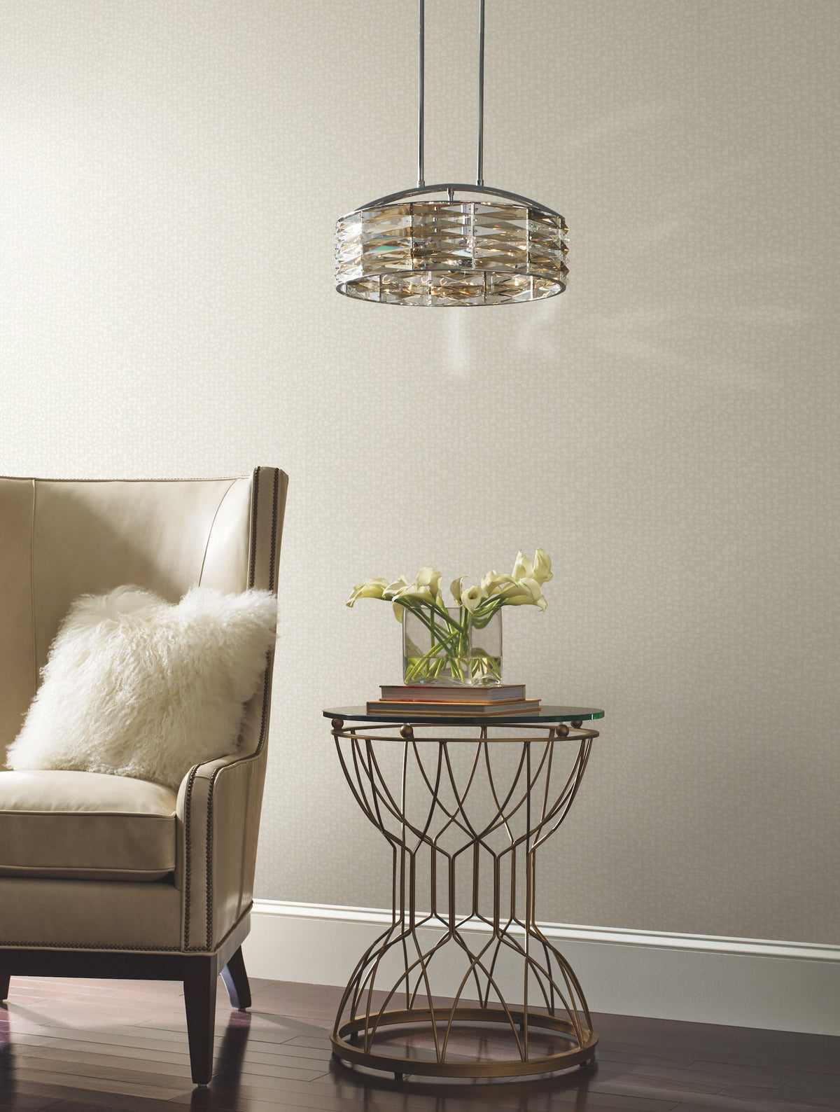 Galaxies Wallpaper with a subtle, small-scale speckled pattern behind a beige armchair and a metal accent table.
