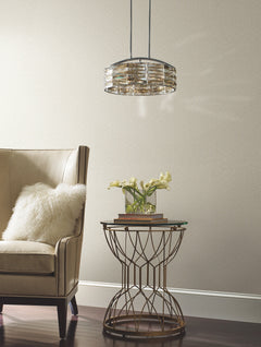 Galaxies Wallpaper with a subtle, small-scale speckled pattern behind a beige armchair and a metal accent table.