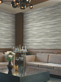 A room featuring Candice Olson Sanctuary Wallpaper with gray and white horizontal wood-grain, brown wainscoting, two sofas, and a coffee table with a vase of flowers.
