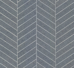 The Ronald Redding Atelier Herringbone Wallpaper by York Wallcoverings features gray concrete-inspired tiles in a chevron pattern, accented with fine white lines along the edges to form a striking, repeating V-shaped geometric design.