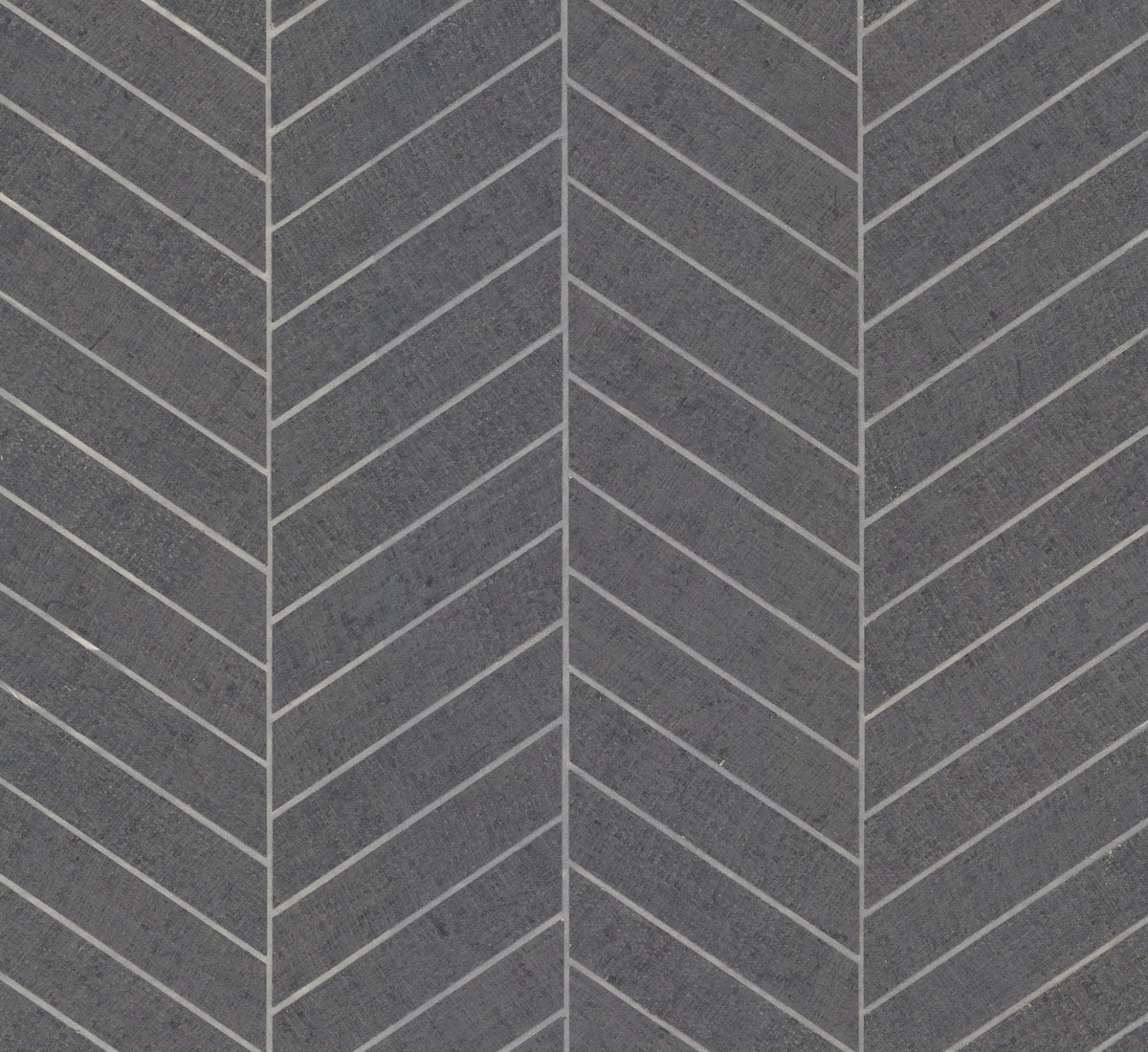 Featuring a dark gray surface with a repeating chevron pattern, the Ronald Redding Atelier Herringbone Wallpaper by York Wallcoverings showcases diagonal white lines meeting at angles to create a striking zigzag effect across the design. The texture appears smooth with a subtly rough finish.
