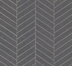 The Ronald Redding Atelier Herringbone Wallpaper by York Wallcoverings features a gray herringbone-patterned surface that mimics rectangular stone tiles, separated by thin white lines, forming a repeating chevron design for a textured and geometric aesthetic.