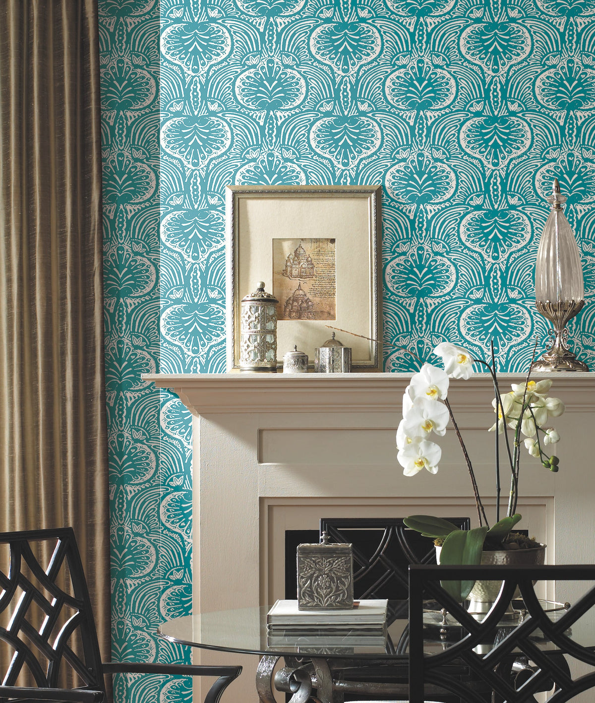 Ronald Redding Lotus Palm Wallpaper in teal and white with a repeating decorative botanical pattern installed behind a fireplace mantel.