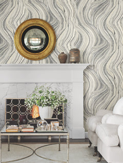 Ronald Redding Streaming Cheetah Wallpaper features a pattern of undulating lines and spotted animal print textures above a fireplace with a mantel, convex mirror, and coffee table.