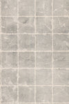 Ronald Redding Metal Leaf Squares Wallpaper by York Wallcoverings features a grid pattern that mimics gray stone tiles with visible grout lines. Its surfaces display a slightly rough, weathered texture and subtle color variations, creating a natural and rustic look.