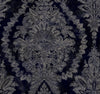 Ronald Redding Charleston Damask Wallpaper featuring a dark navy blue background with a faded, beige, ornate damask floral pattern.