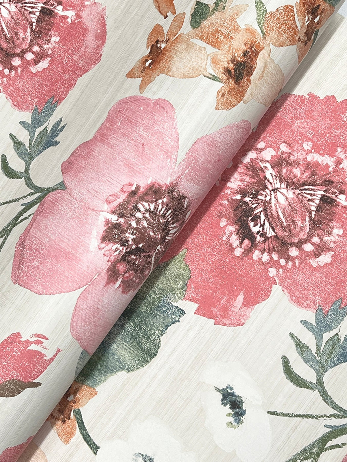 A close-up of the Evelyn Floral Wallpaper by York Wallcoverings, featuring an elegant floral pattern with large pink, red, and orange flowers, green leaves, and a soft beige background. The wallpaper is shown slightly curved in the middle.