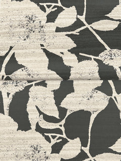 Solange Botanical Wallpaper by York Wallcoverings showcases a bold black and white abstract pattern of large, overlapping leaves and floral motifs with textured shading, arranged across a visible central seam.