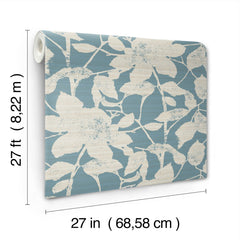 Solange Botanical Wallpaper by York Wallcoverings features a white floral pattern on a blue background. Each roll measures 27 feet (8.22 m) in length and 27 inches (68.58 cm) in width.