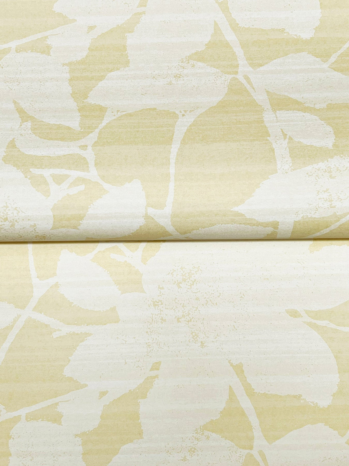 Solange Botanical Wallpaper by York Wallcoverings features a soft beige background with a subtle, abstract white leaf and branch pattern. Its textured design creates an organic, natural look that’s perfect for interior decoration.