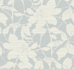 The Solange Botanical Wallpaper by York Wallcoverings features a white floral and leaf pattern set against a light blue-gray background, enhanced with a textured and subtly distressed finish throughout the design.