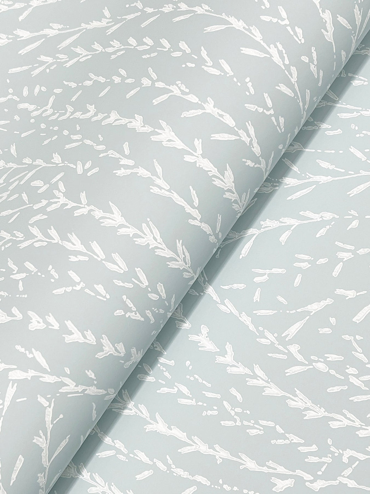 Close-up of Willow Song Botanical Wallpaper by York Wallcoverings, featuring a light blue background with a delicate white abstract pattern inspired by nature, resembling branches or leaves for a textured look.